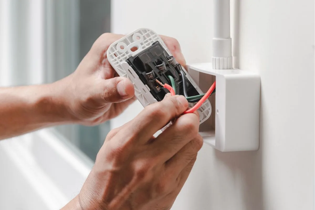 Electrician installing a wall switch